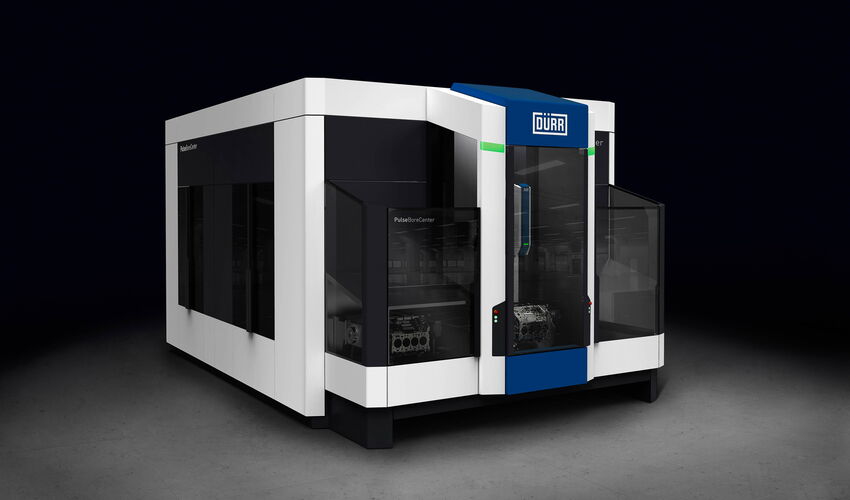 Dürr PulseBoreCenter manufacturing system featuring a cubic machine design, large glass surfaces and a centrally integrated process chamber for high-pressure water jet processing of cylinder bores.