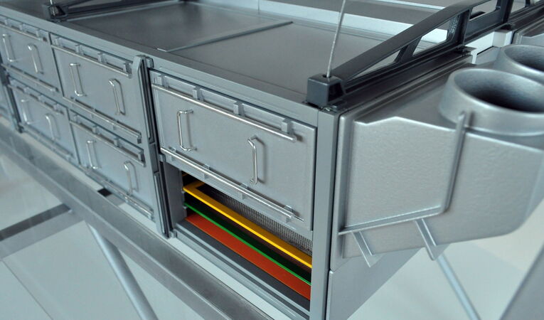 Close-up of the OSC trade show model featuring opened service panels and the visible screen assembly, highlighting the machine's service-oriented product design.