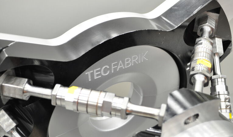 Close-up of a precision-engineered robotic gripper featuring CNC-machined aluminum components and integrated pneumatic connections for industrial automation.