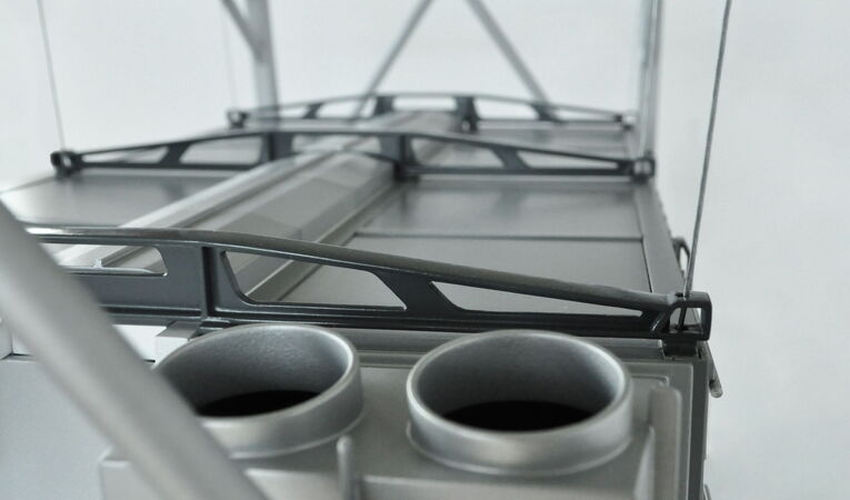 Close-up of the Dieffenbacher OSC trade show model featuring the suspended steel cable construction and precisely recreated functional components.