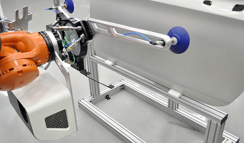 Industrial design of the Leanfit robotic system featuring an ergonomic end effector for human-robot collaboration and automated manufacturing at the Daimler TecFabrik.